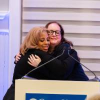 Khadijah Johnson hugs friend while receiving her award